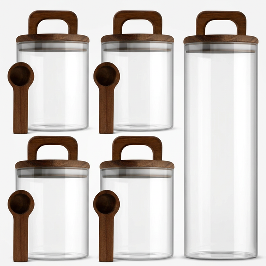 Five glass canisters with wooden handled lids and scoops on white background